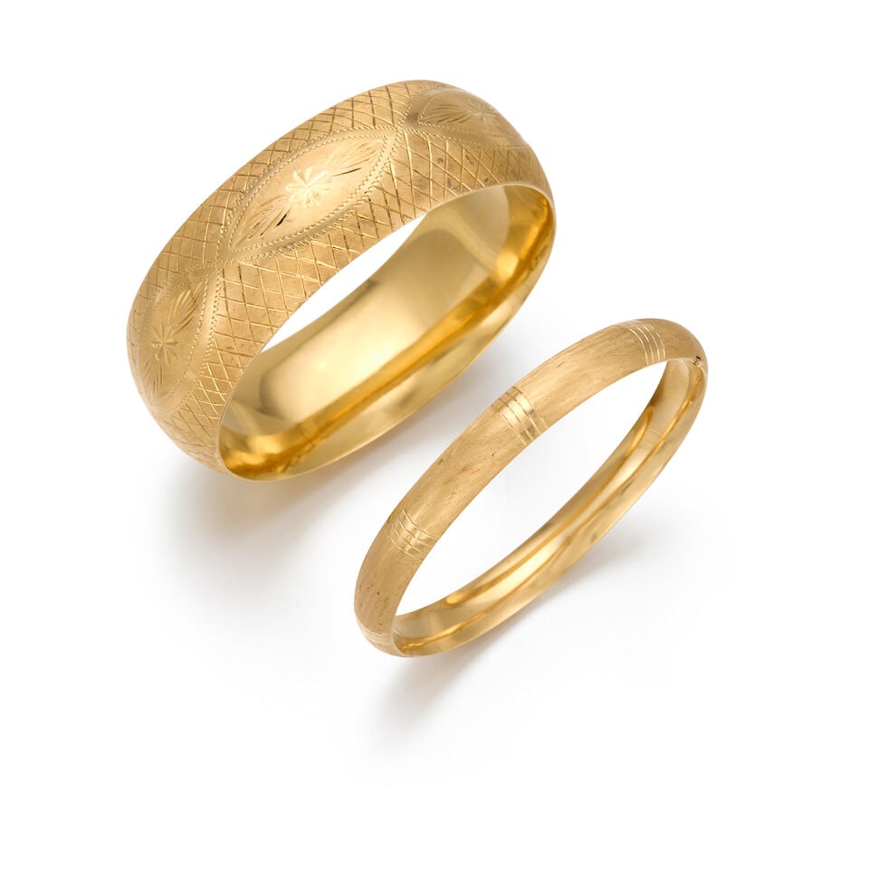 TWO 14K YELLOW GOLD BANGLES: TWO 14K YELLOW GOLD BANGLES • A gold bangle, inner circumference 6 3/4 in. • A gold bangle, inner circumference 6 3/4 in. • Estimated gross weight: 45.4 grams Footnotes: OVERALL COND
