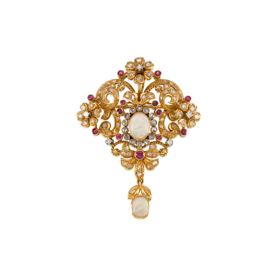 18K YELLOW GOLD, OPAL, RUBY, AND DIAMOND BROOCH: 18K YELLOW GOLD, OPAL, RUBY, AND DIAMOND BROOCH • Two oval cabochon opals measuring approximately 7.69mm x 6.13mm x 2.35mm and 9.05mm x 7.14mm x 3.06mm • Thirteen round shaped rubies