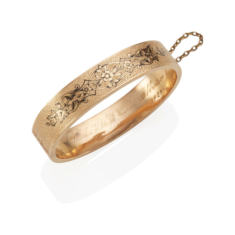 YELLOW GOLD AND ENAMEL VICTORIAN ERA BANGLE BRACELET: YELLOW GOLD AND ENAMEL VICTORIAN ERA BANGLE BRACELET • 14k yellow gold and 18K yellow gold safety chain • Black taille d'epergne enamel • Length: 6 1/4 in • Estimated gross