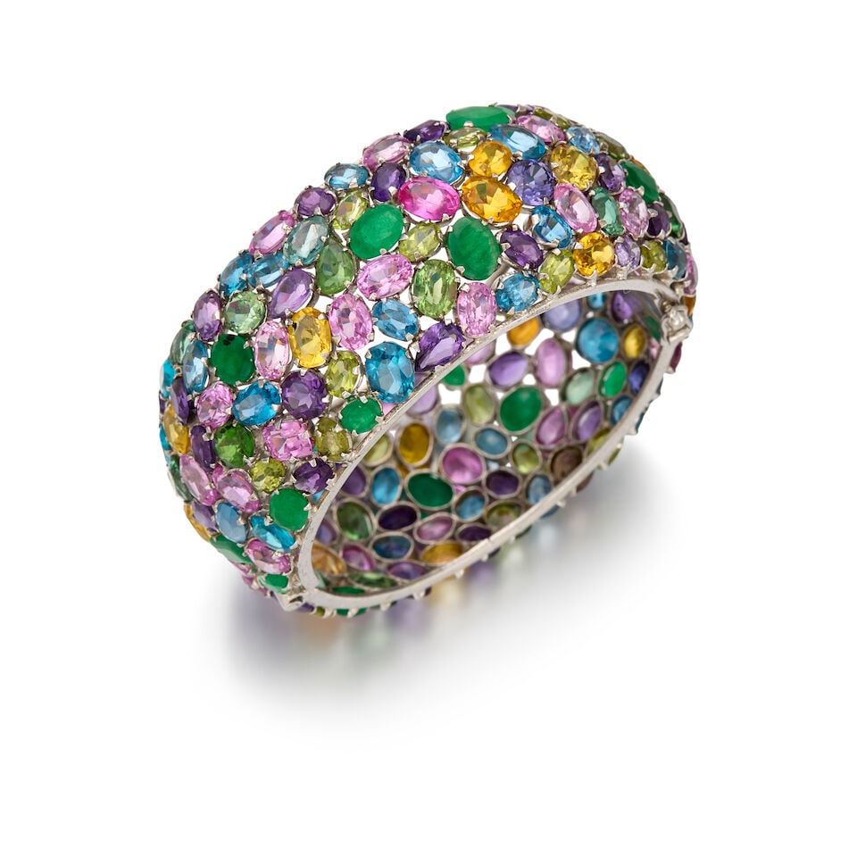 SILVER AND MULTI-GEMSTONE BANGLE BRACELET: SILVER AND MULTI-GEMSTONE BANGLE BRACELET • Numerous gemstones consisting of emerald, topaz, peridot, kunzite, amethyst, and citrine in various shapes and sizes ranging from 4.51mm x 4.20mm to