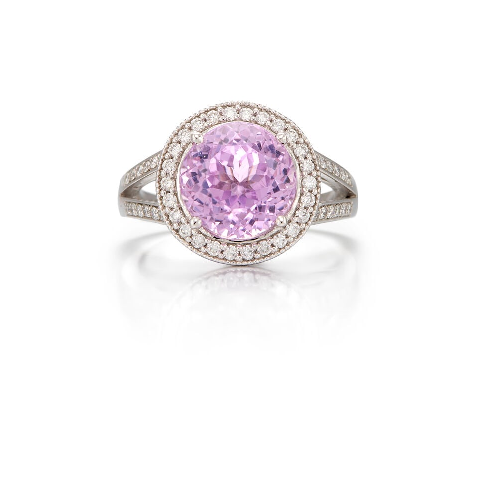 PLATINUM, KUNZITE AND DIAMOND RING: PLATINUM, KUNZITE AND DIAMOND RING • One round shaped kunzite weighing approximately 4.50 carats total • Numerous round brilliant cut diamonds measuring approximately 1.40mm • Size