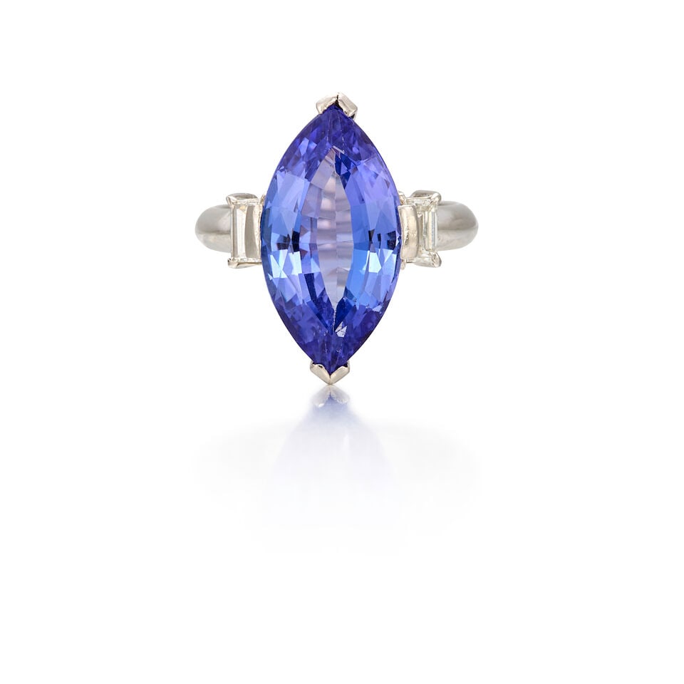 PLATINUM, TANZANITE, AND DIAMOND RING: PLATINUM, TANZANITE, AND DIAMOND RING • One marquise shaped tanzanite weighing approximately 4.50 carats • Two rectangular shaped diamonds weighing approximately 0.12 carat total •