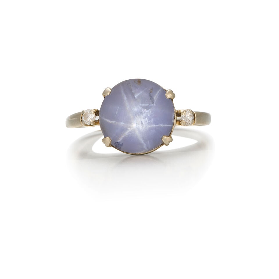 14K WHITE GOLD, STAR SAPPHIRE, AND DIAMOND RING: 14K WHITE GOLD, STAR SAPPHIRE, AND DIAMOND RING • One round shaped star sapphire measuring approximately 10.95mm x 11.49mm x 6.06mm • Two round shaped diamonds weighing approximately 0.04