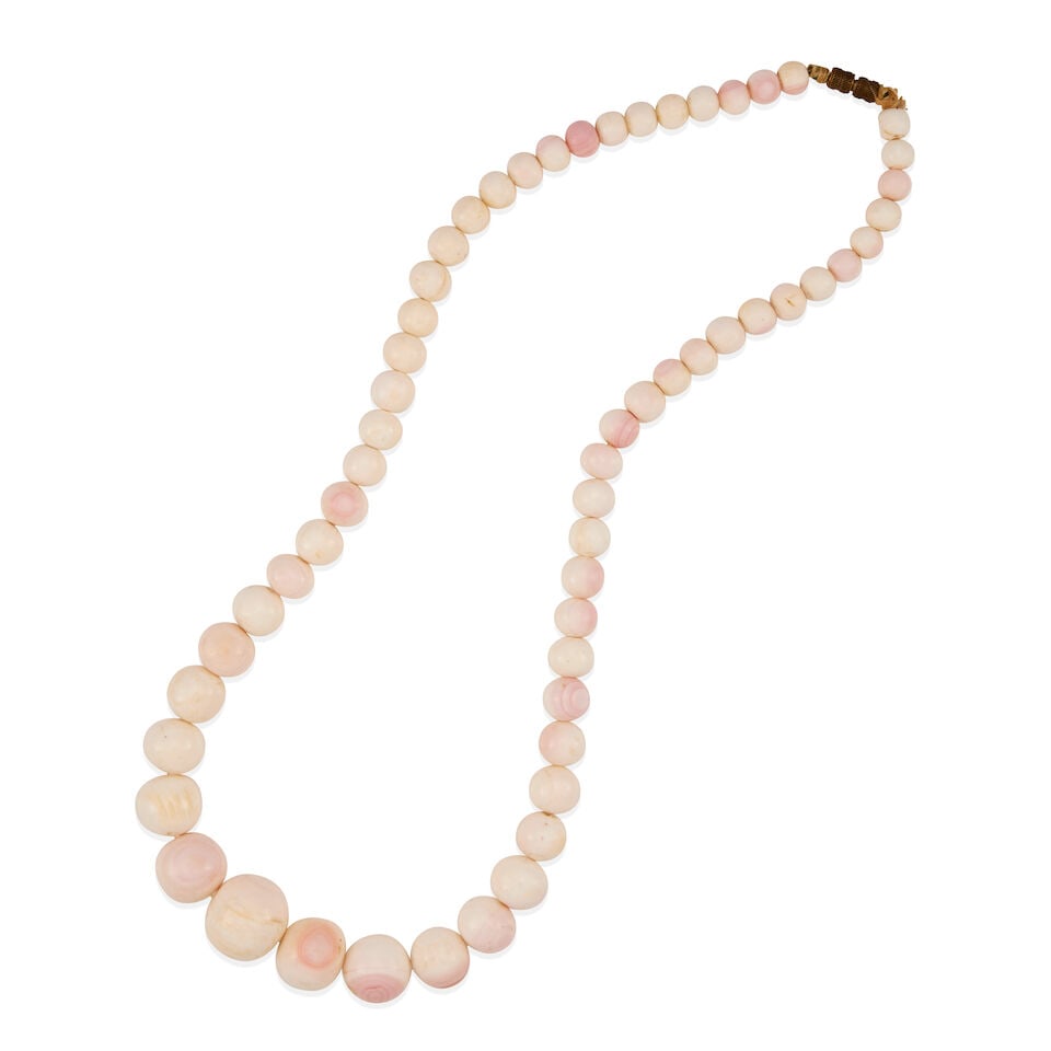 A CORAL BEAD NECKLACE: A CORAL BEAD NECKLACE • Metal clasp • Numerous drilled coral beads measuring approximately 7.10mm to 19.50mm in diameter • Length 22 in. • Estimated gross weight: 108.1 grams