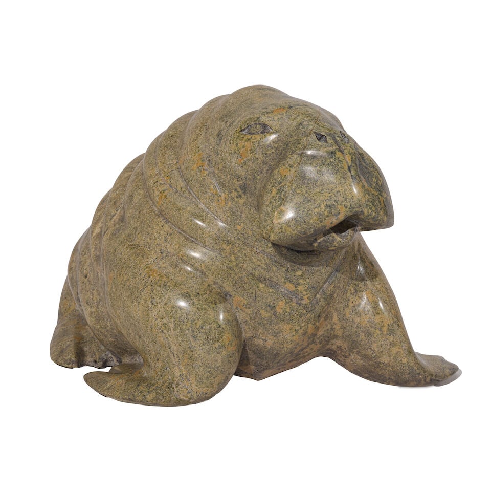 A Mathewsie Saviadguk carved stone sculpture: Mathewsie Saviadguk Inuit, Kinngait/Cape Dorset, (b. 1950), a carved stone sculpture of a walrus, signed on the underside in syllabics, with a break to one flipper, lacking tusks. height 9in, width