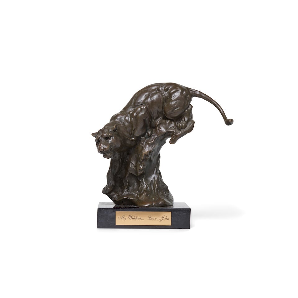 A Chita Rivera Bronze Sculpture of a Wildcat: A Chita Rivera Bronze Sculpture of a Wildcat Bronze sculpture with a plaque inscribed, 'My Wildcat ... Love, John' on stone plinth. Signed by artist Milo. Approximately 9.5 in. Lot to be sold without