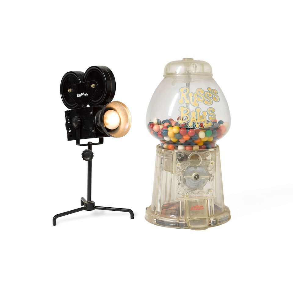 A Russ Meyer gumball machine and lamp: A Russ Meyer gumball machine and lamp Comprising a 'Carousel' brand gumball machine with 'Russ's Balls' handpainted to the face, still in working order, with gumballs and pennies still inside; and a b