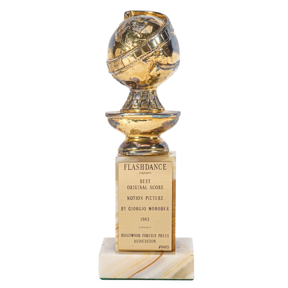 A Best Original Score Golden Globe Statuette for Flashdance: A Best Original Score Golden Globe Statuette for Flashdance Paramount Pictures, 1983. Cast metal globe on marble base, brass plaque reading 'Flashdance / Best Original Score / Motion Picture / by Gior