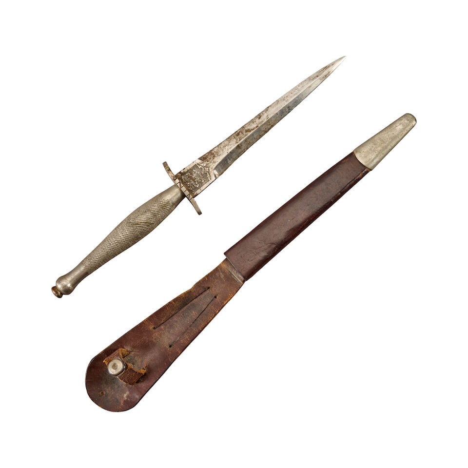 A WORLD WAR II FIRST PATTERN FAIRBAIRN-SYKES COMMANDO KNIFE WITH 'S' GUARD AND SHEATH. (1 of 4)