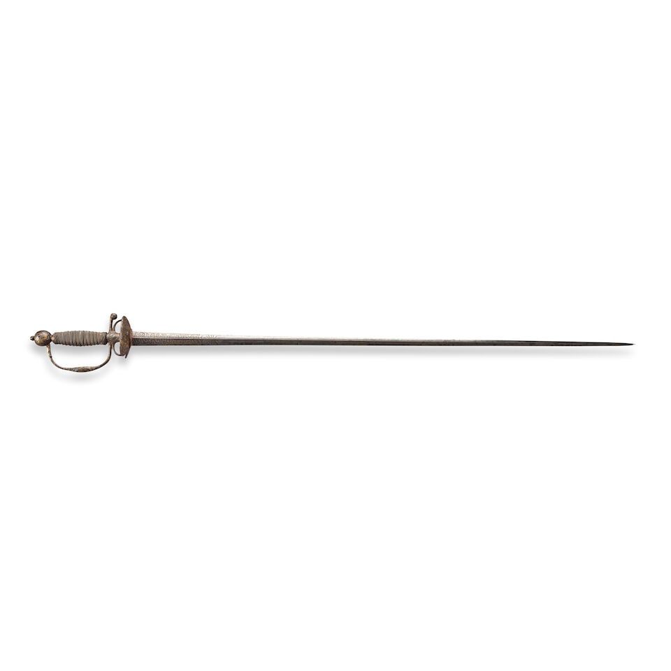 AN 18TH CENTURY EUROPEAN CHASED AND GILDED IRON HILTED SMALL SWORD,: AN 18TH CENTURY EUROPEAN CHASED AND GILDED IRON HILTED SMALL SWORD, third quarter of the 18th century. The hilt with chased and gilded military iconography, twisted silver wire covered grip; triangula