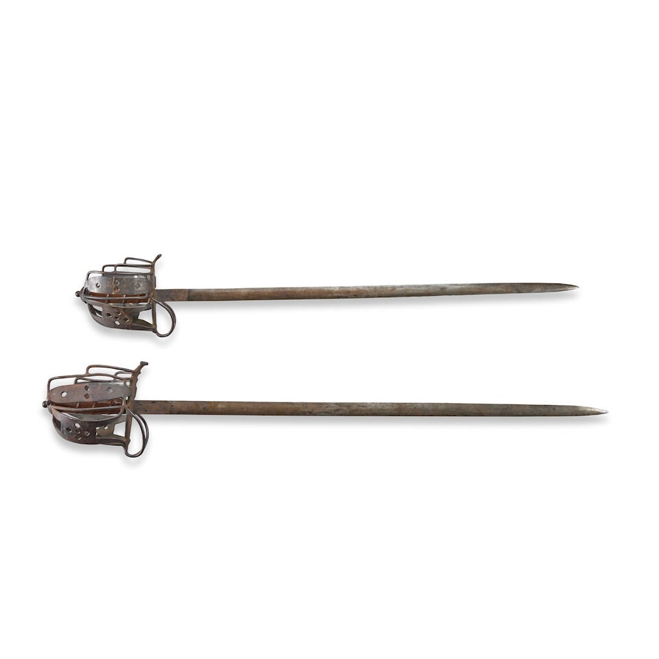 TWO VICTORIAN REPRODUCTION BASKET HILT BROADSWORDS.: TWO VICTORIAN REPRODUCTION BASKET HILT BROADSWORDS. The hilts with modern weld seams and joins, leather covered grip and straight double-edge blades. Overall lg. 38 1/2 in. For further information on