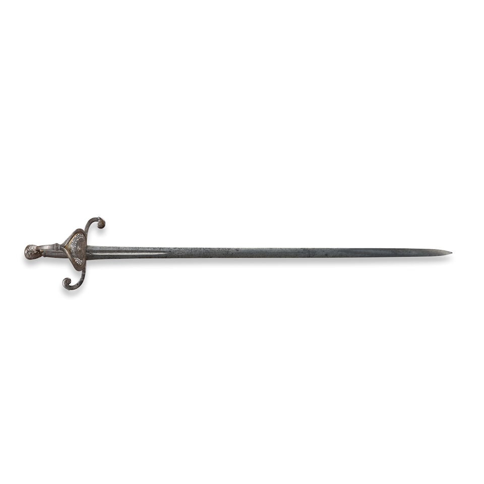 AN EARLY 16TH CENTURY GERMAN BROADSWORD.: AN EARLY 16TH CENTURY GERMAN BROADSWORD. The iron hilt with traces of gilding, pierced and repousse guard, large scrolling quillons with foliate decoration, large foliate decorated pommel and twisted