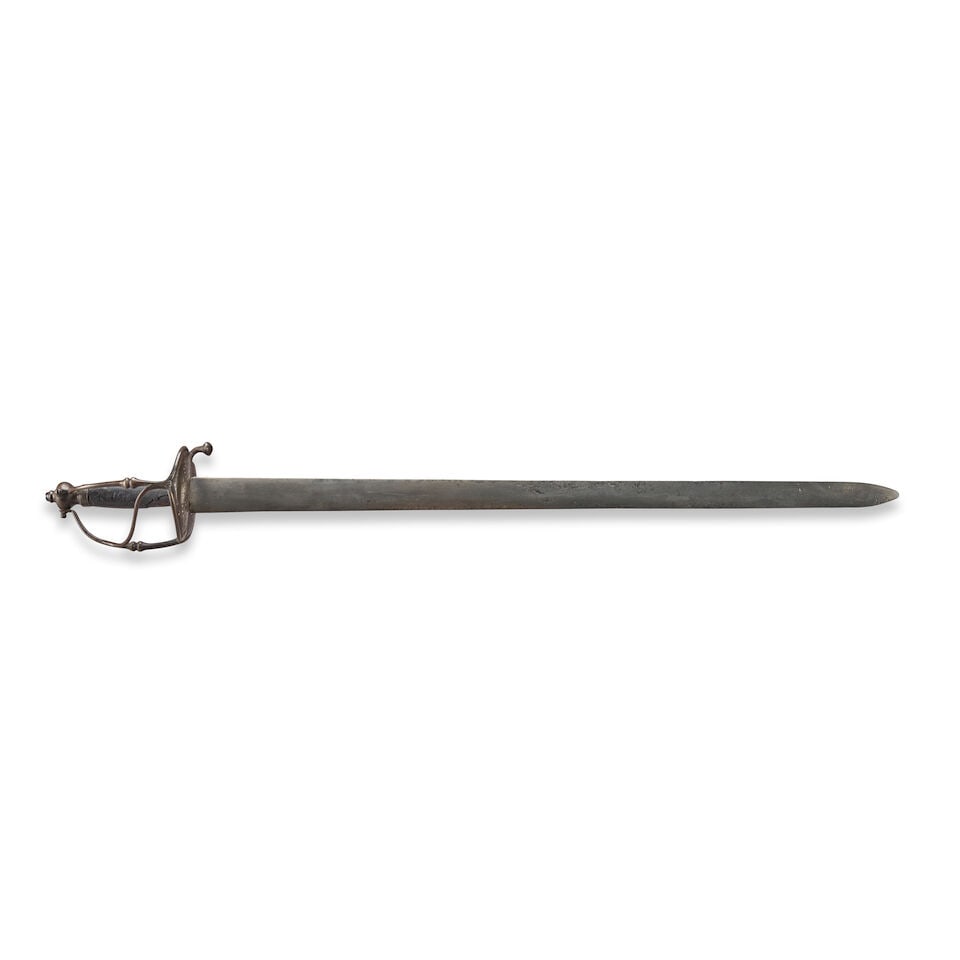 A NORTHERN EUROPEAN CAVALRY BROADSWORD,: A NORTHERN EUROPEAN CAVALRY BROADSWORD, second half of the 17th century. The iron Walloon hilt comprising bilobate shells with round and star-shaped piercings and incorporating a thumb ring;