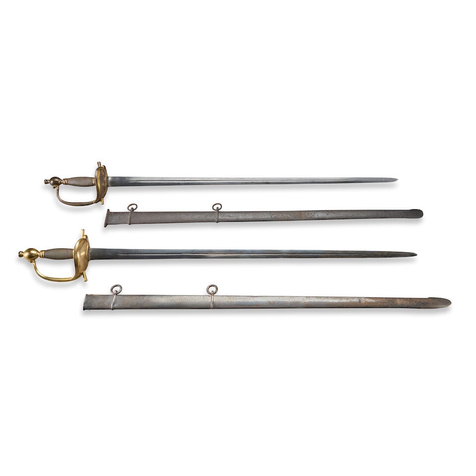 TWO BRITISH PATTERN 1796 HEAVY CAVALRY OFFICER'S DRESS SWORDS,: TWO BRITISH PATTERN 1796 HEAVY CAVALRY OFFICER'S DRESS SWORDS, c. 1800. The swords with gilded brass hilts featuring heavy 'boat' guards, ovoid pommels and twisted wire covered grips; straight double-