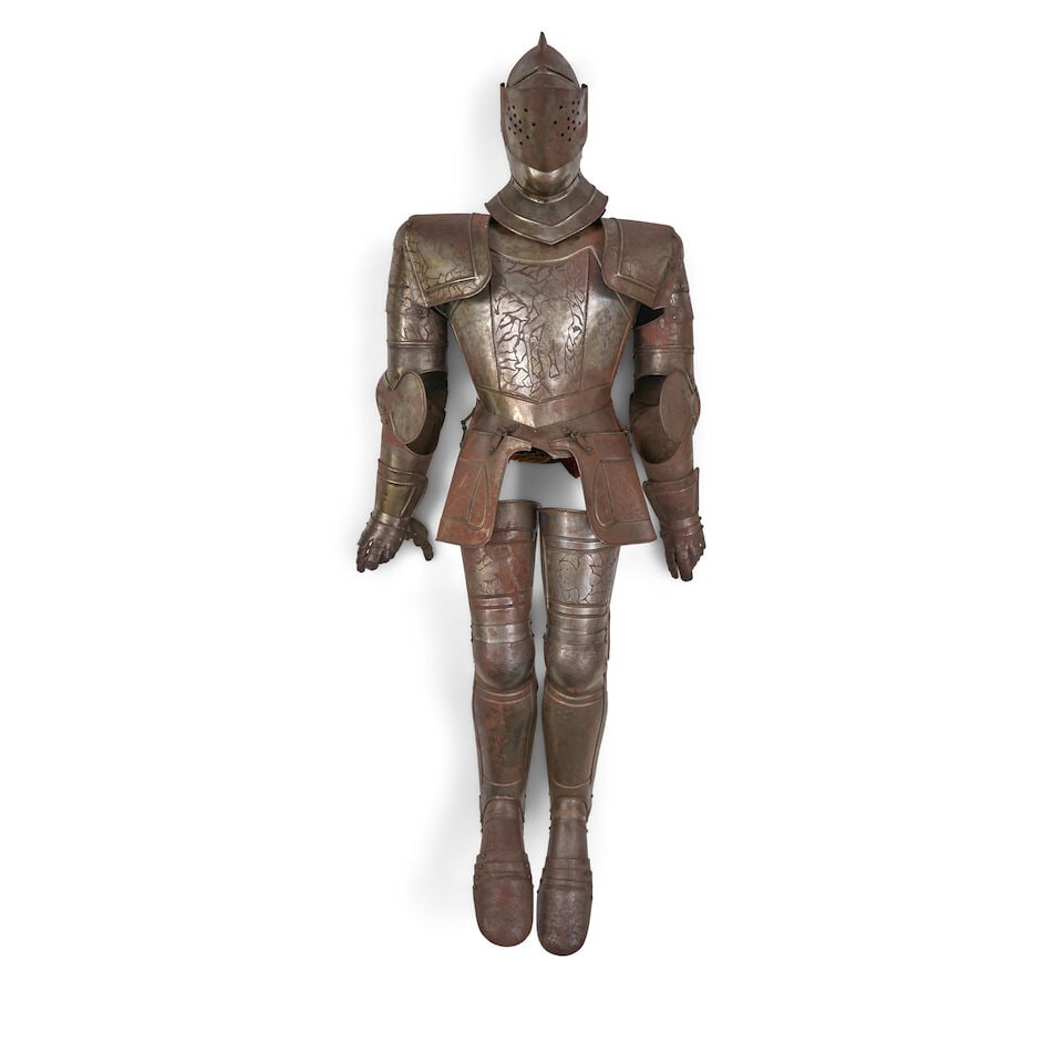 A VICTORIAN SUIT OF ARMOUR.: A VICTORIAN SUIT OF ARMOUR. The steel suit with decoratively etched plates, articulated joints, gauntlets and feet; armature to allow the armor to stand is not intact. Ht. 76 in. For further