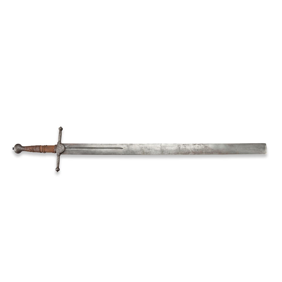 A GERMAN EXECUTIONER'S SWORD.: A GERMAN EXECUTIONER'S SWORD. The large hilt with ornate foliate decoration on the cross bar and pommel, wood grip with oxidized partial twisted iron wire wrapping; straight double-edge blade with