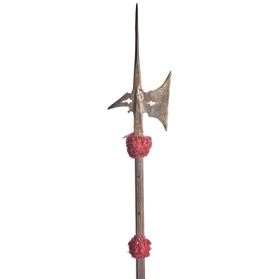 A 17TH CENTURY GERMANIC HALBERD ON A SHORTENED POLE.: A 17TH CENTURY GERMANIC HALBERD ON A SHORTENED POLE. The head with a tall tapering spike above a socket with a heavy pierced blade and beak and long straps secured to a hard wood pole. Ht. 70 1/2