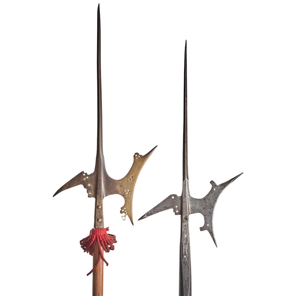 TWO 17TH CENTURY EUROPEAN HALBERDS ON SHORTENED POLES.: TWO 17TH CENTURY EUROPEAN HALBERDS ON SHORTENED POLES. The heads with tall narrow spikes above a socket with crescent blade and angular beak, the straps shortened and on later poles. Ht. to 95 1/2