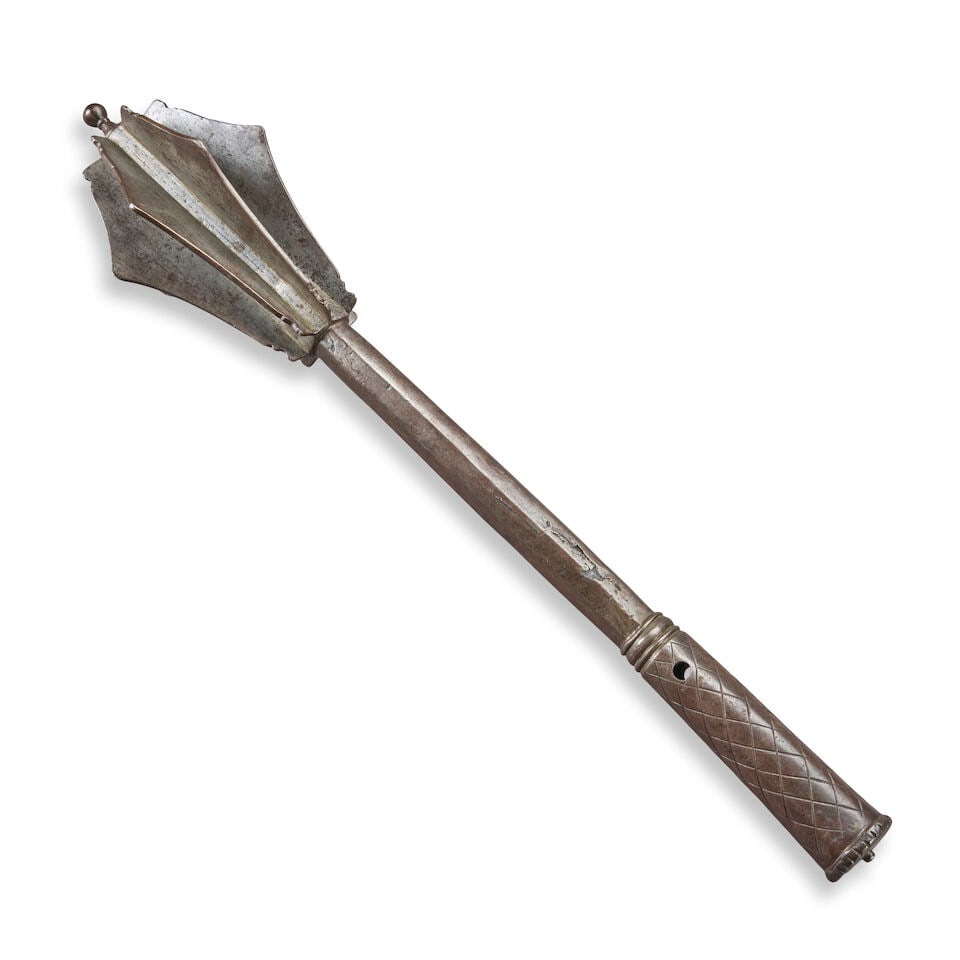 A 16TH/17TH CENTURY IRON MACE.: A 16TH/17TH CENTURY IRON MACE. The head with seven angular fins fitted and brazed to a central haft with file checkered grip. Lg. 20 3/4 in. For further information on this lot please visit