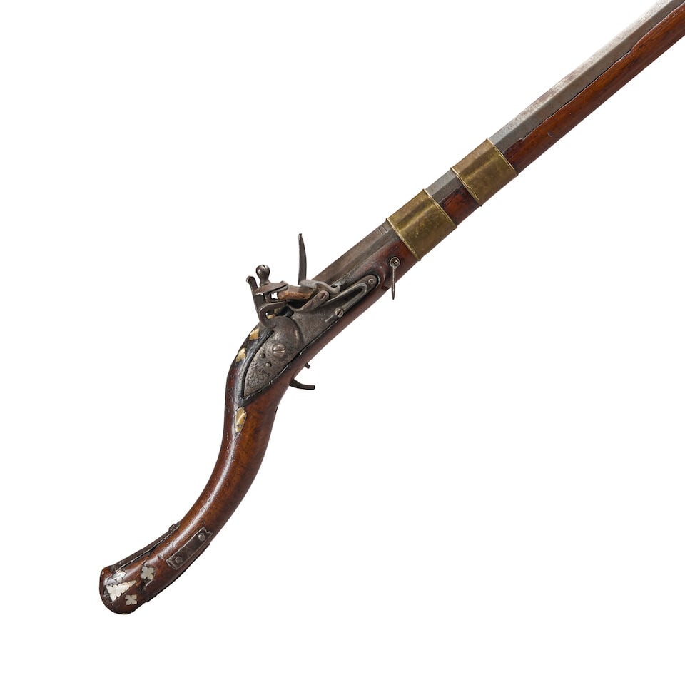AN AFGHAN JEZAIL FLINTLOCK RIFLE AND FLASK,: AN AFGHAN JEZAIL FLINTLOCK RIFLE AND FLASK, 19th century. 50 7/8 in., .58 caliber rifled Damascus octagon barrel; 1799-dated East India Company lock; walnut/hard wood stock with shell inlays, sheet