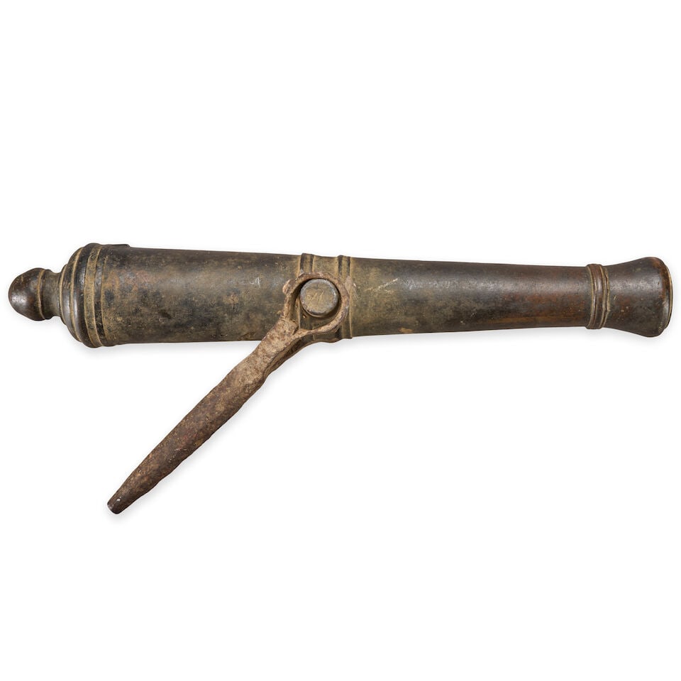 A LATE 18TH/EARLY 19TH CENTURY BRONZE SWIVEL GUN.: A LATE 18TH/EARLY 19TH CENTURY BRONZE SWIVEL GUN. Unmarked, 1 3/8 in. bore, the trunnions mounted at the center line of the barrel, with an iron yoke. Overall lg. 21 1/4 in. For further information