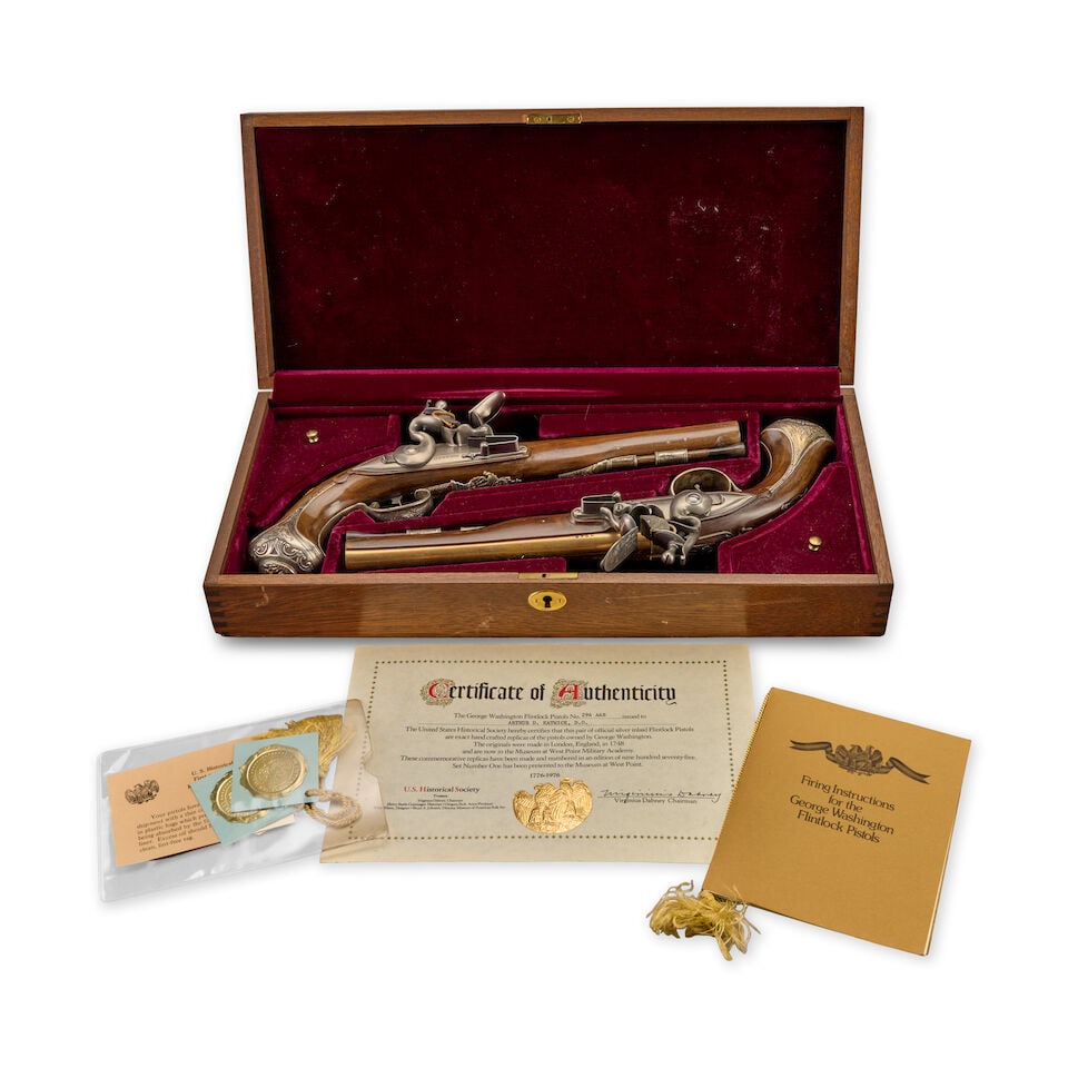 A CASED PAIR OF SILVER-MOUNTED REPRODUCTION GEORGE WASHINGTON FLINTLOCK PISTOLS.: A CASED PAIR OF SILVER-MOUNTED REPRODUCTION GEORGE WASHINGTON FLINTLOCK PISTOLS. Serial numbers 294A and 294B, 8 in., .58 caliber brass barrels marked 'LONDON' on the top; convex lock plates with poin