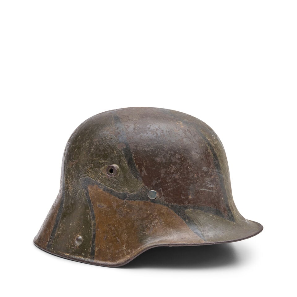 A WORLD WAR I GERMAN MODEL 1916 CAMOUFLAGE-PAINTED STAHLHELM. (1 of 3)