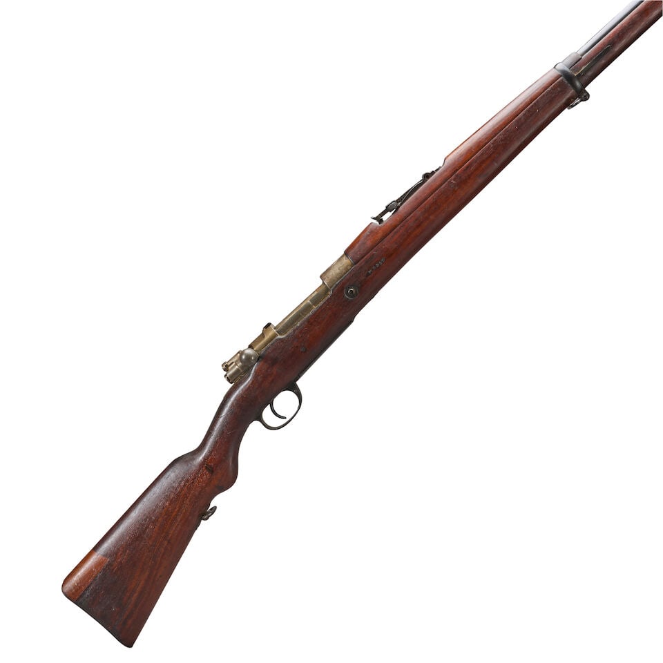 AN ARGENTINE MODEL 1909 BOLT ACTION INFANTRY RIFLE, Curio or Relic firearm: AN ARGENTINE MODEL 1909 BOLT ACTION INFANTRY RIFLE, c. 1909-1930. Serial number N0310, 7.65.53mm Rimless caliber, blued barrel, bright receiver with Argentine crest on the top, hard wood stock, visibl