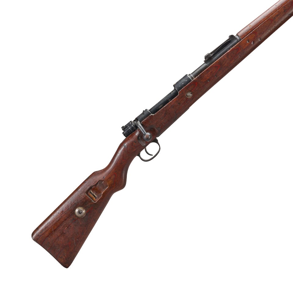 A WORLD WAR II GERMAN K98 BOLT ACTION RIFLE, Curio or Relic firearm: A WORLD WAR II GERMAN K98 BOLT ACTION RIFLE, 1940. Serial number 3104n, 7.92x57mm caliber, blued barrel and receiver marked '42' and '1940' on the top, intact waffenamt markings and proof marks; lamin