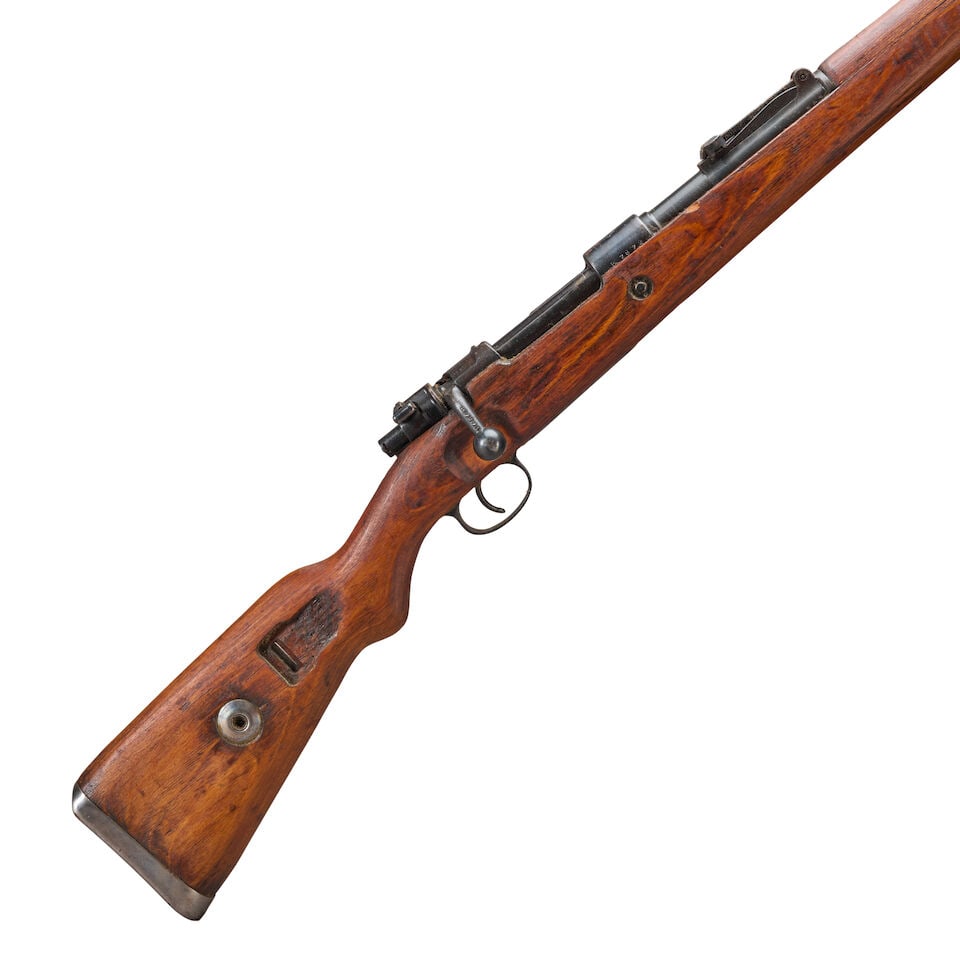 A YUGOSLAVIAN MODEL 48 BOLT ACTION RIFLE. Curio or Relic firearm: A YUGOSLAVIAN MODEL 48 BOLT ACTION RIFLE. Serial number B7872, 7.92x57mm caliber, blued barrel and receiver with Yugoslavian crest on the top, the left side marked 'PREDUZECE 44', laminated stock with