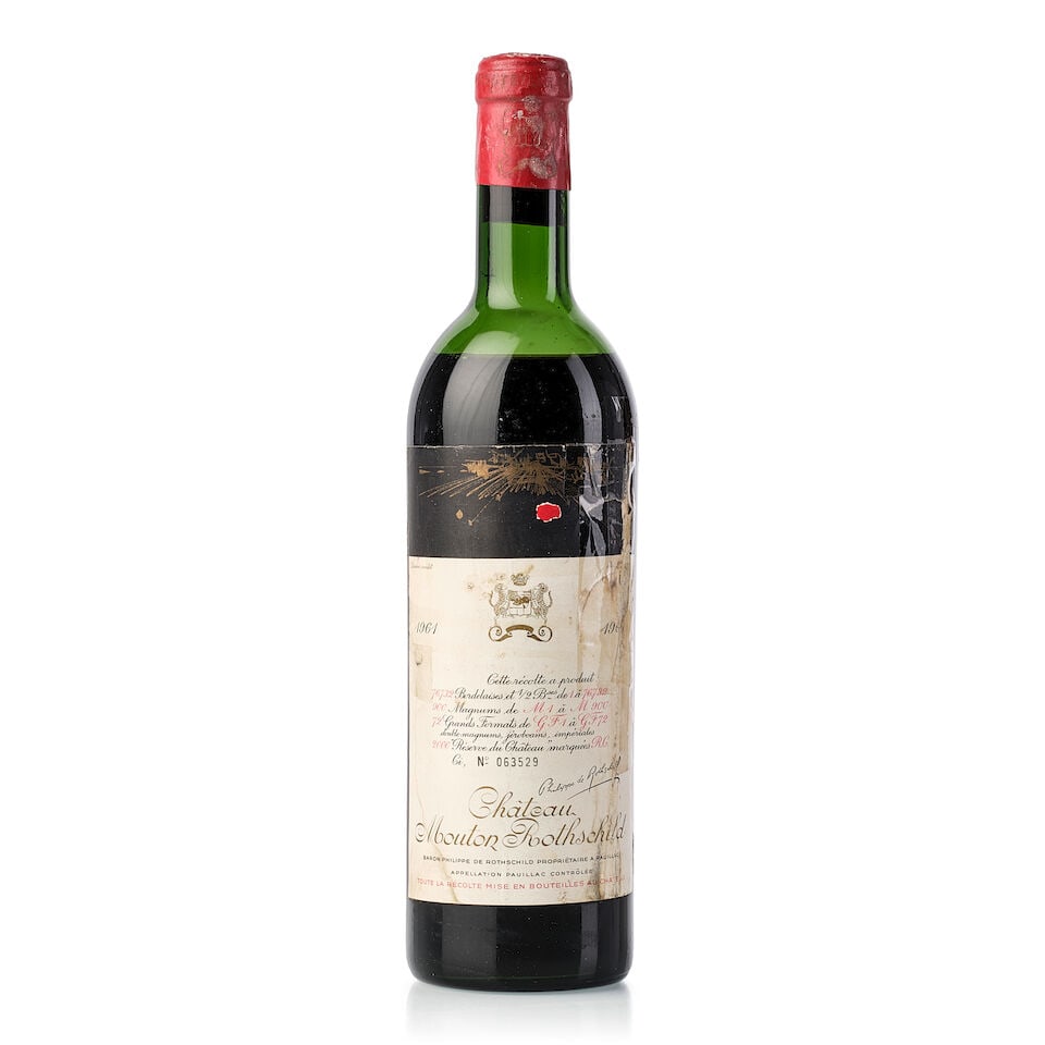 Château Mouton Rothschild, 1961 (1x 750ml): Château Mouton Rothschild, 1961 (1x 750ml) Region: Bordeaux Fill Level: mid shoulder Capsule: corroded and damaged Cork: slightly protruded, signs of old seepage Label: heavily torn, heavily bin-
