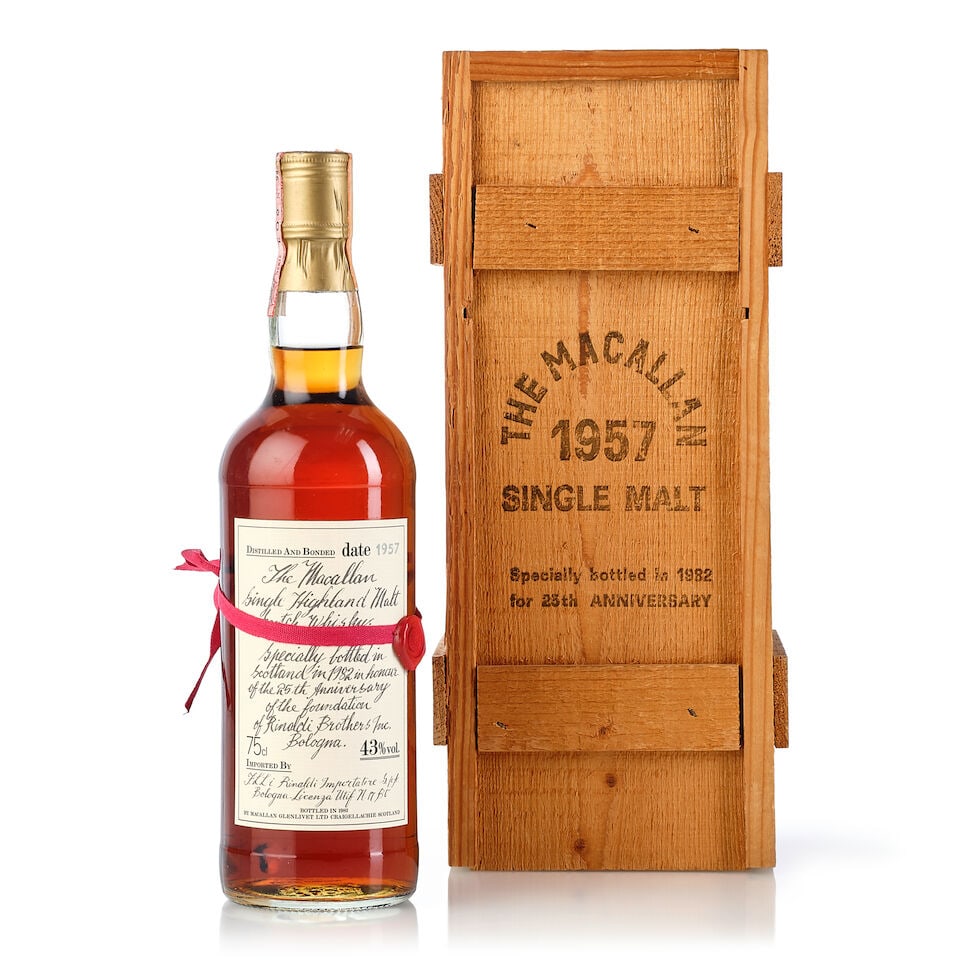 The Macallan Red Ribbon, 1957 (1x 750ml): The Macallan Red Ribbon, 1957 (1x 750ml) Region: Speyside Fill Level: into neck Capsule: slightly scuffed capsule Label: slightly bin-soiled label Packaging: stained wooden presentation case, with let