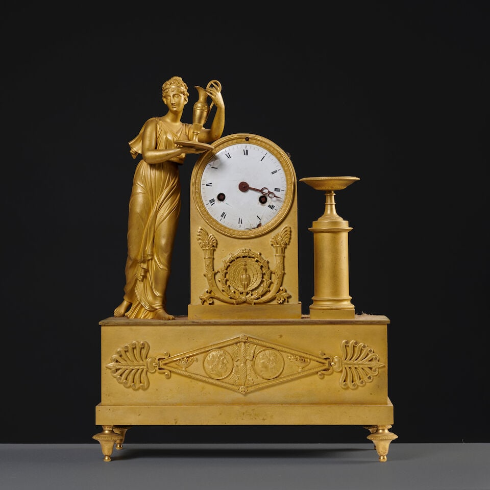 Pendule en bronze doré et ciselé à la jeune servante d'époque Restauration A...: Pendule en bronze doré et ciselé à la jeune servante d'époque Restauration A gilt-bronze clock depicting a young servant, first half of the 19th century Le cadran