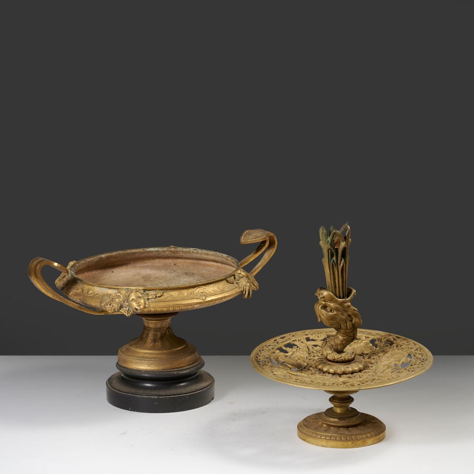 Une coupe en forme de fontaine au dauphin, et une coupe en bronze doré et marbre noir, fin...: Une coupe en forme de fontaine au dauphin, et une coupe en bronze doré et marbre noir, fin du XIXe siècle A 19th century cup in the form of a fountain with a dolphin, and a cup in gilt-bronz