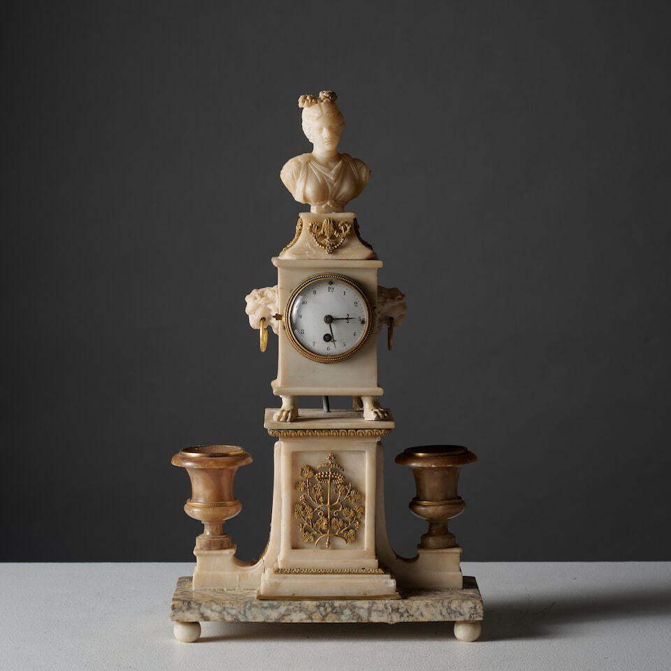 Pendule en marbre blanc figurant un autel surmonté d'un buste de femme, Madrid, XIXe si...: Pendule en marbre blanc figurant un autel surmonté d'un buste de femme, Madrid, XIXe siècle A clock in white marble depicting an altar surmounted by a female bust, Madrid, 19th