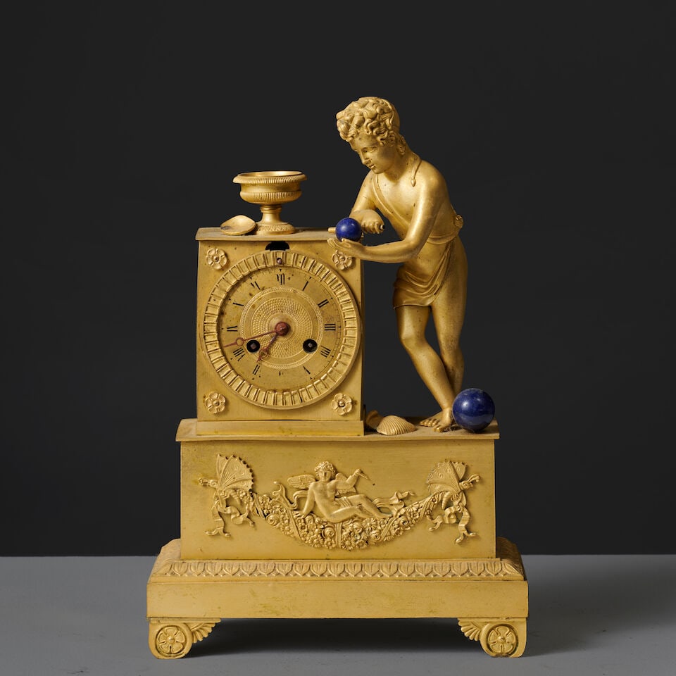Pendule en bronze doré et ciselé figurant un amour jouant d'époque Restauration A...: Pendule en bronze doré et ciselé figurant un amour jouant d'époque Restauration A gilt-bronze clock depicting a playing Cupid, first half of the 19th century Le cadran est inscrit dans