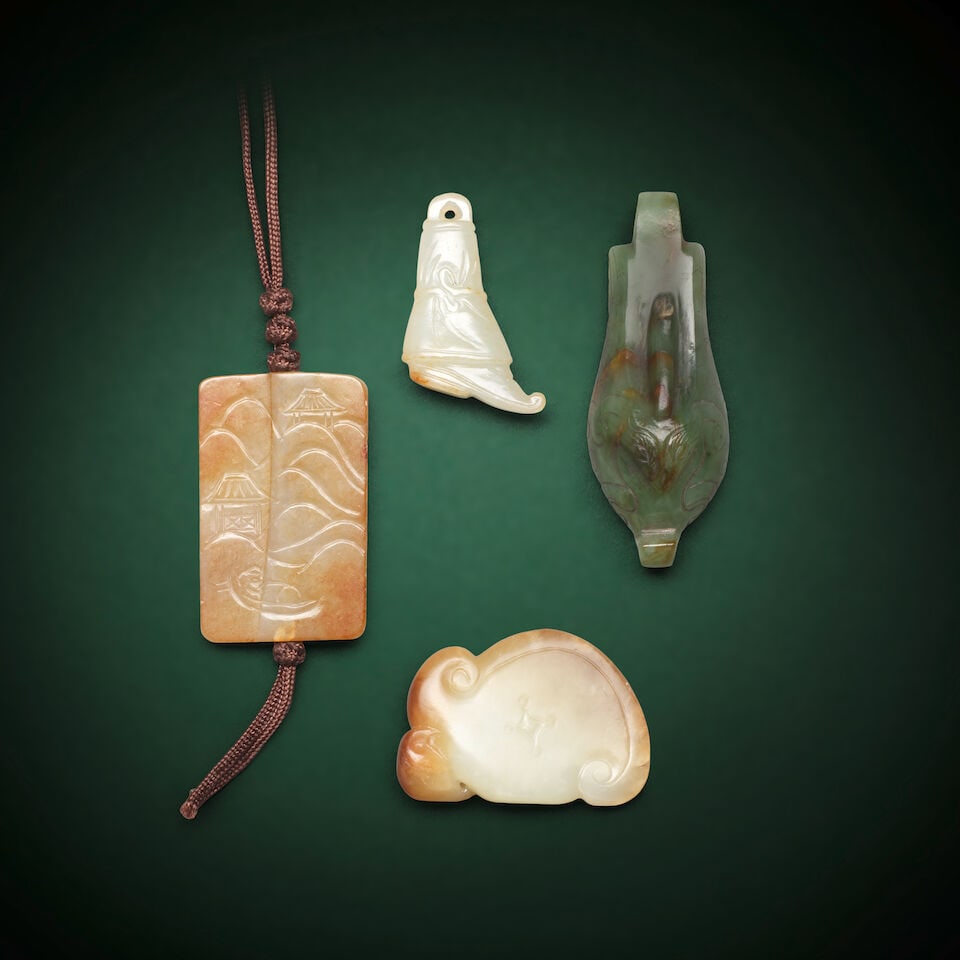 THREE JADE PENDANTS AND ONE PLAQUE Qing Dynasty (4): THREE JADE PENDANTS AND ONE PLAQUE Qing Dynasty Comprising: a pale green and russet jade plaque of axe form, surmounted by a recumbent elephant; a russet and pale green jade plaque carved on one side 