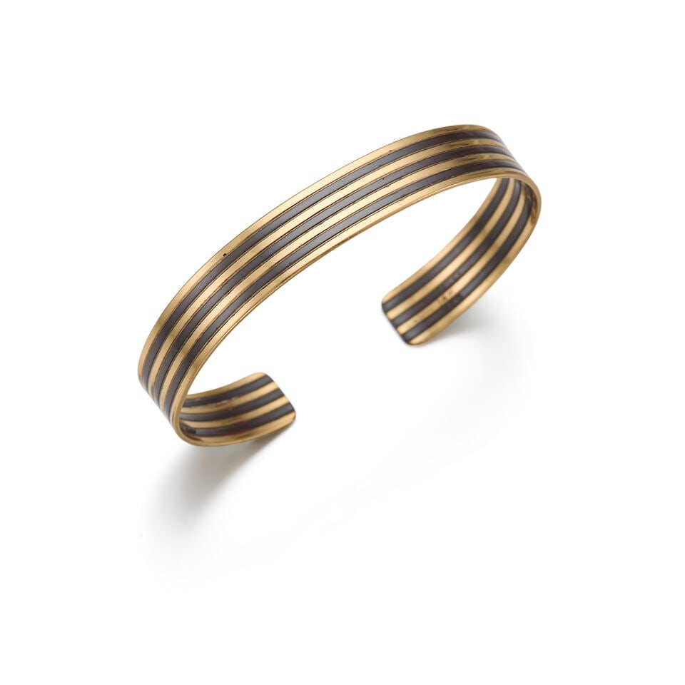 PAUL MORELLI: A 14K YELLOW GOLD AND SILVER CUFF BRACELET: PAUL MORELLI: A 14K YELLOW GOLD AND SILVER CUFF BRACELET • Stamped MORELLI • Inner Circumference 6 in., 3/4 in gap • Estimated gross weight: 12.7 grams Footnotes: OVERALL CONDITION: 