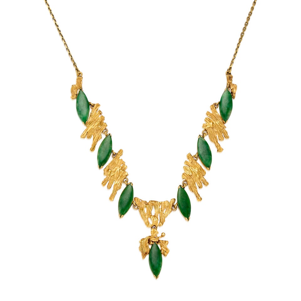 GOLD AND JADE NECKLACE: GOLD AND JADE NECKLACE • 12K and 14K yellow gold • Seven marquise shaped jade pieces measuring approximately 15.82mm x 6.01mm x 1.10mm • Length 17 in. • Estimated gross