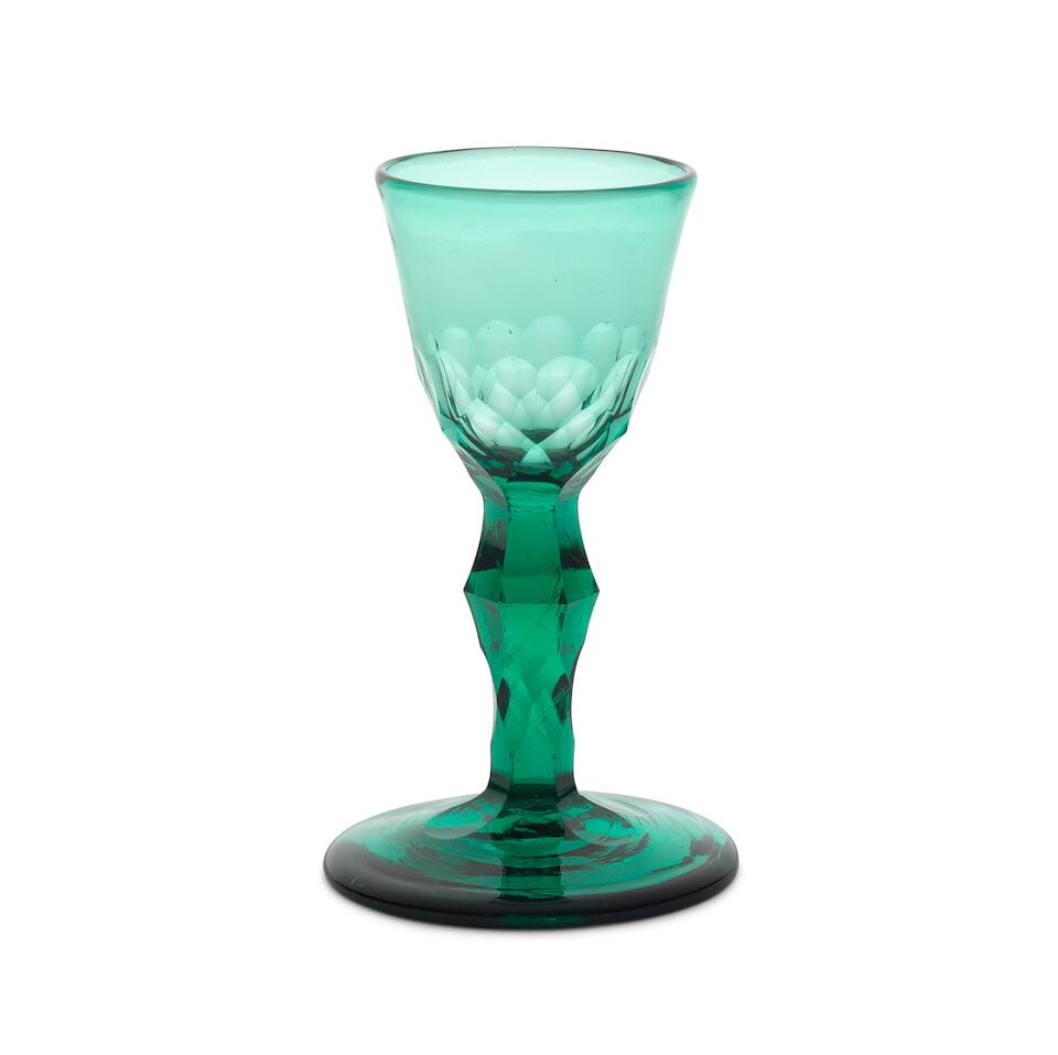 A rare emerald-green tinted facet stem small wine or cordial glass, circa 1780: A rare emerald-green tinted facet stem small wine or cordial glass, circa 1780 In deep green glass and of attractive small size, the round funnel bowl cut with facets to the lower part, on a