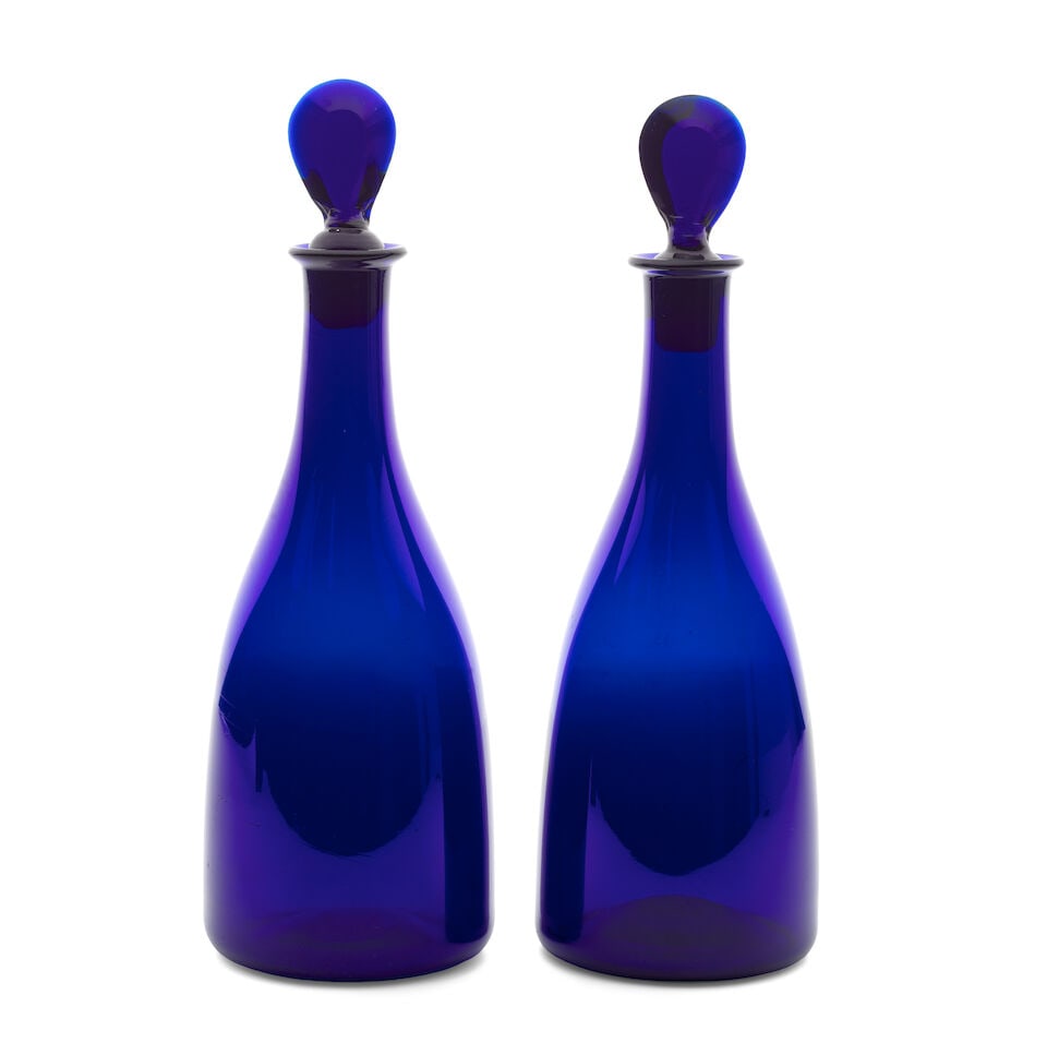 A fine pair of blue glass decanters and stoppers, circa 1780-90: A fine pair of blue glass decanters and stoppers, circa 1780-90 In deep cobalt-blue glass and of 'taper' shape, with lozenge stoppers, 30.5cm and 31cm high (4) Footnotes: Provenance Damment