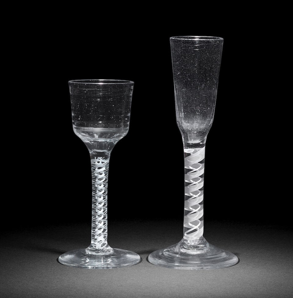 An opaque twist 'Lynn' wine glass and an opaque twist ratafia glass, circa 1765: An opaque twist 'Lynn' wine glass and an opaque twist ratafia glass, circa 1765 The first with an ogee bowl moulded with a series of seven distinctive concentric rings, on a stem containing two pairs