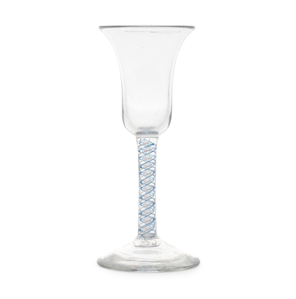 A blue colour twist wine glass, circa 1765: A blue colour twist wine glass, circa 1765 The generous bell bowl on a slender stem enclosing an opaque white multi-ply corkscrew edged on both sides in translucent blue, alternating with a single