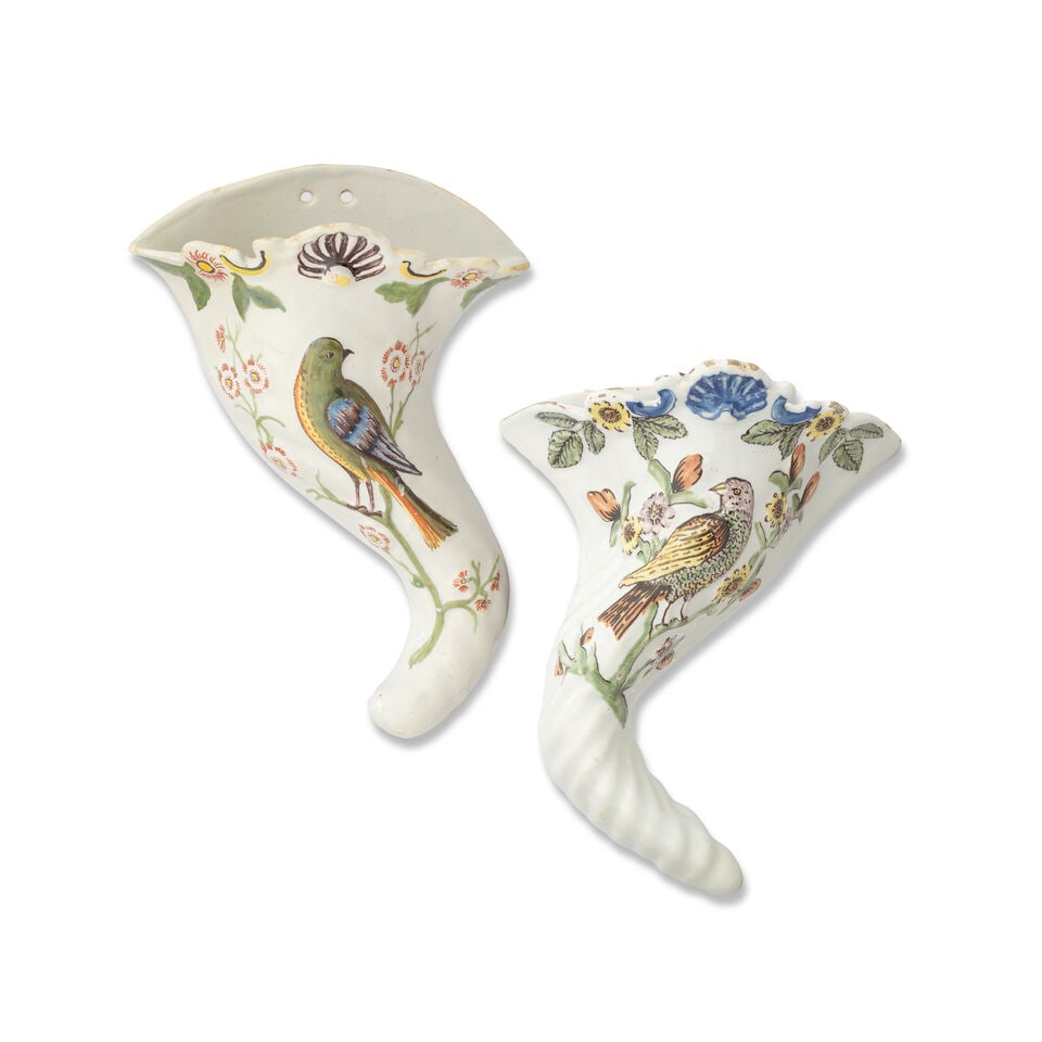 Two Liverpool delftware wall pockets and a Bristol tile, circa 1760-70: Two Liverpool delftware wall pockets and a Bristol tile, circa 1760-70 The first two modelled as cornucopias, a bird perched on a flowering branch moulded in low-relief, carefully picked out in 'Fazak