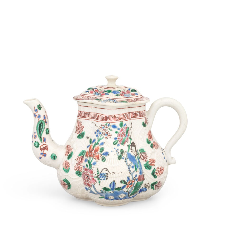 A Staffordshire saltglaze stoneware teapot and cover, circa 1755: A Staffordshire saltglaze stoneware teapot and cover, circa 1755 Of lobed form, moulded in crisp detail with shells and fruiting oak, painted in an attractive polychrome palette with a fine Chinese la