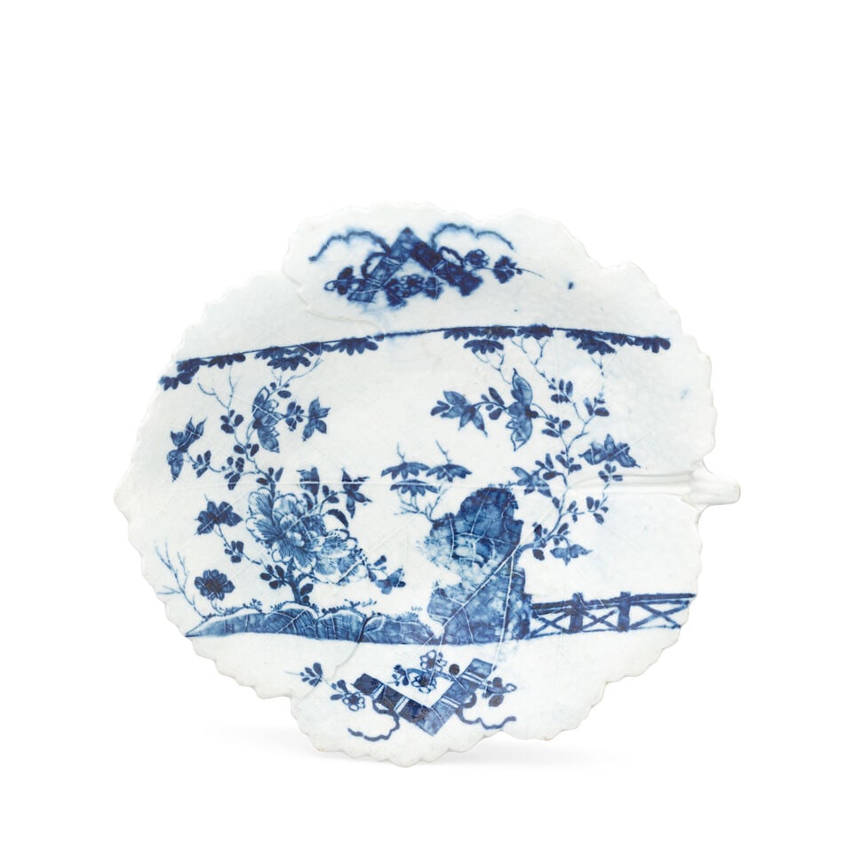 A rare Worcester leaf dish, circa 1756-58: A rare Worcester leaf dish, circa 1756-58 Crisply moulded as a single fig leaf with delicate veining, painted in blue with the 'Chinese Scroll Peony' pattern (I.D.13) of flowers growing from a fence