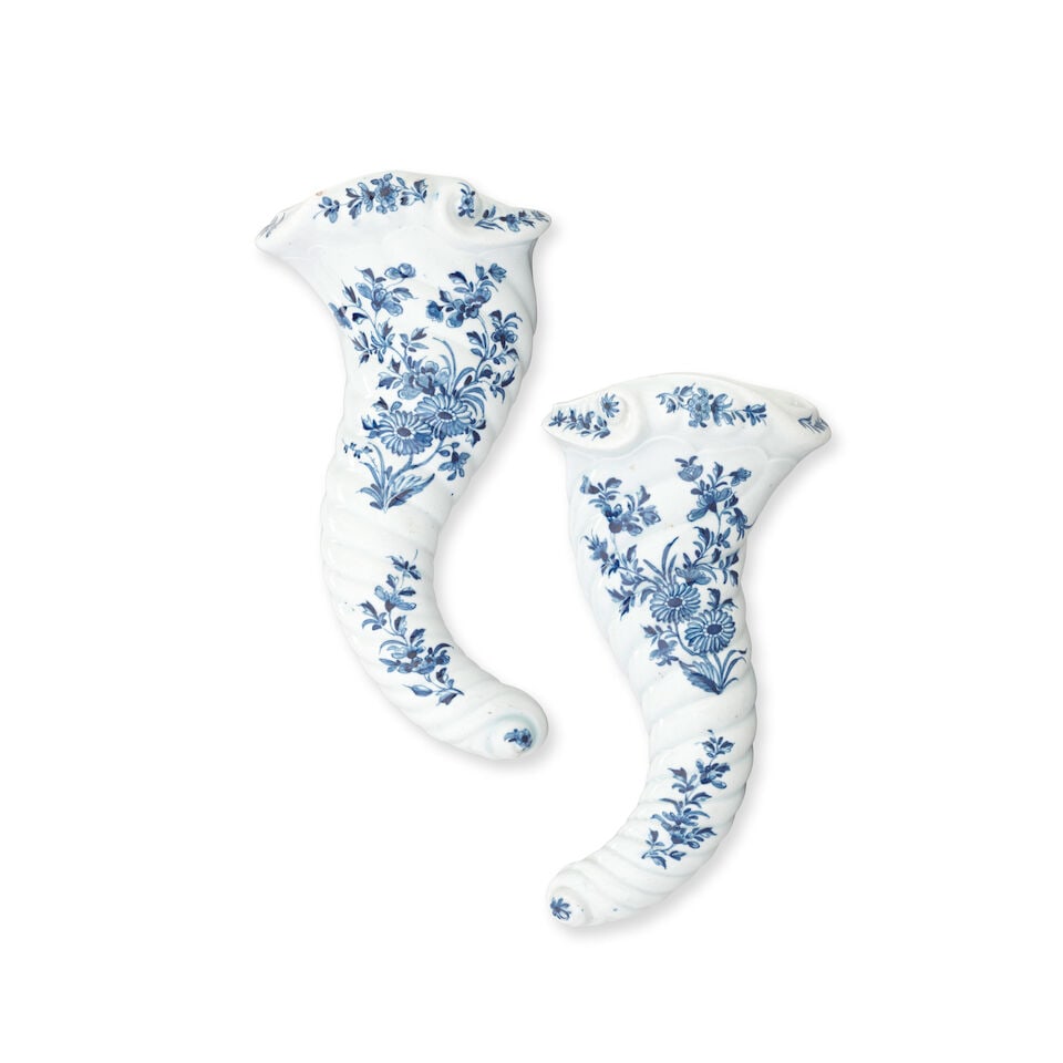 A rare pair of Worcester cornucopias, circa 1760: A rare pair of Worcester cornucopias, circa 1760 Of spiralling horn shape, painted in blue with the 'Cornucopia Daisy' pattern with a loose spray of flowers including two daisy-like blooms, above a