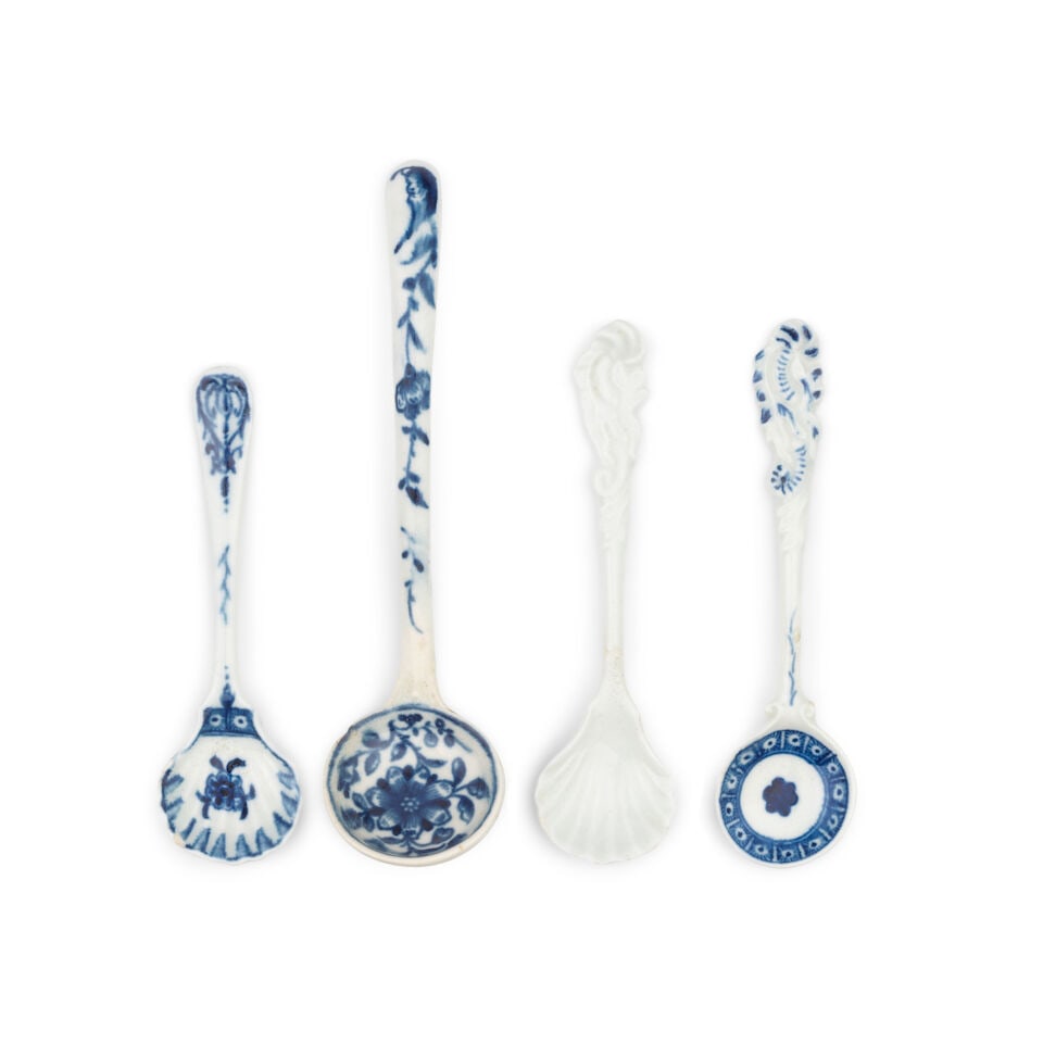 Four Worcester spoons, circa 1765-75: Four Worcester spoons, circa 1765-75 One with a round bowl and rococo scroll handle, painted in blue with a flowerhead within a cell border, 9.9cm long, one with a round bowl and plain curved handle,