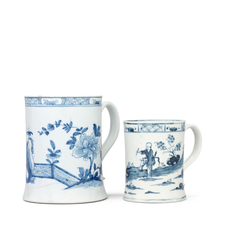 Two Worcester mugs, circa 1754-56: Two Worcester mugs, circa 1754-56 Of cylindrical form with gently spreading feet, applied with broad grooved strap handles, the larger tankard painted in blue with the 'Zig-Zag Fence' pattern, a