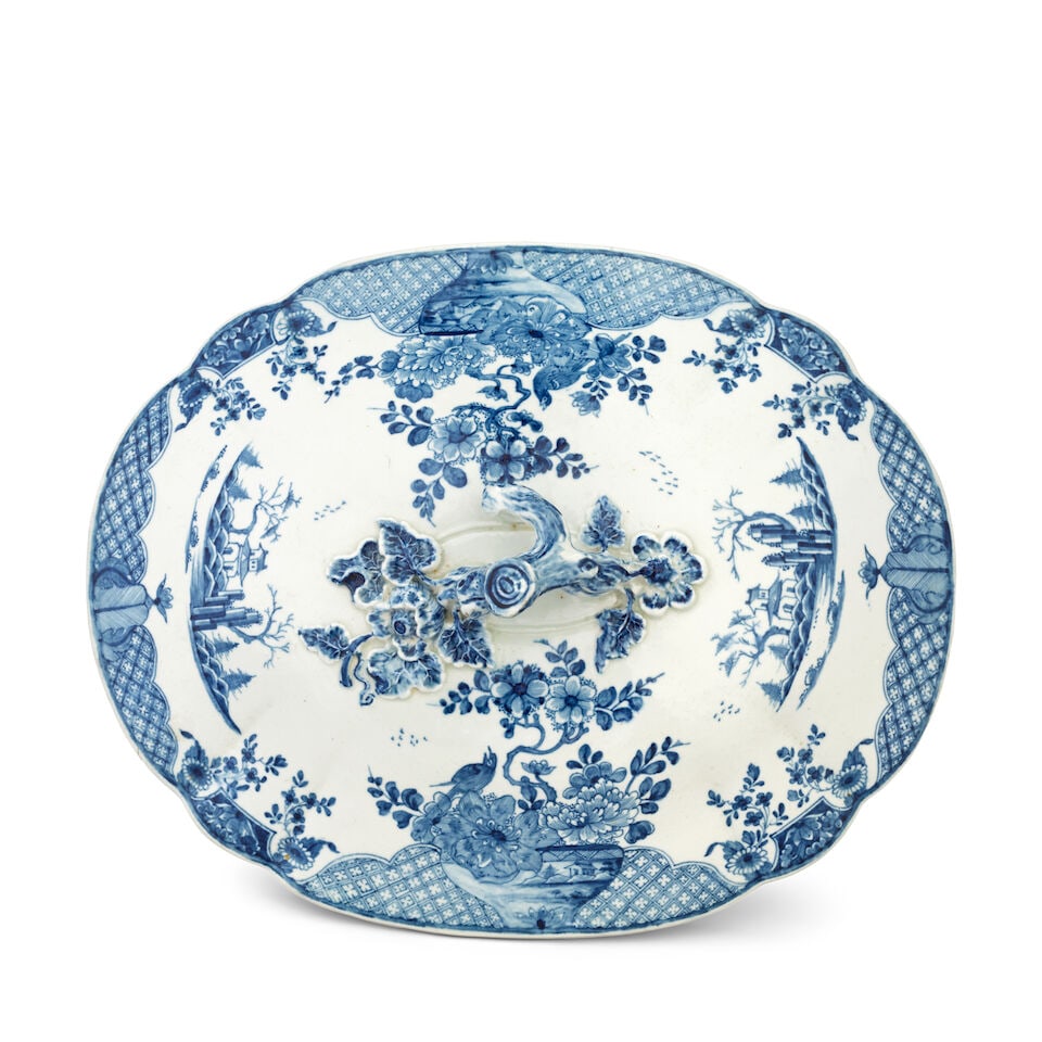 An important Worcester tureen cover, circa 1754: An important Worcester tureen cover, circa 1754 Of lobed oval shape with an elaborate rustic twig finial sprouting flowers and veined leaves, painted in blue with two porcelain bowls containing flower